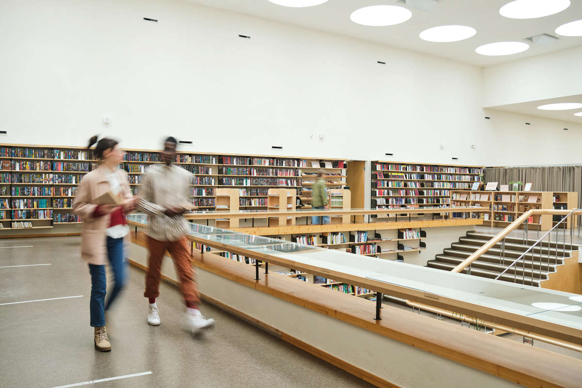 Canadian libraries themed stock - blurred motion of people walking along the corridor in big library